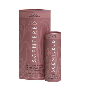 Love Therapy Balm | Scentered with rose, patchouli, and cedarwood, presented in a pink tube and matching sleeve for skincare and wellness care.