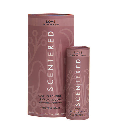 Love Therapy Balm | Scentered with rose, patchouli, and cedarwood, presented in a pink tube and matching sleeve for skincare and wellness care.