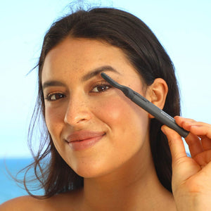 Woman using Heated Eyelash Curler | Chella near her eye with a soft smile, demonstrating the beauty and wellness device for enhancing eyelashes.