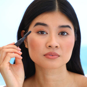 Woman applying the Heated Eyelash Curler | Chella to her eyelashes, demonstrating the beauty and wellness device designed to enhance eyelash appearance.