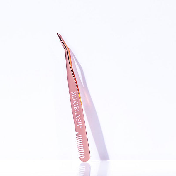 Rose gold lash applicator tool with a curved tip and comb edge, designed for precise eyelash extension application, labeled Lash Applicator - Rose Gold | Moxielash.