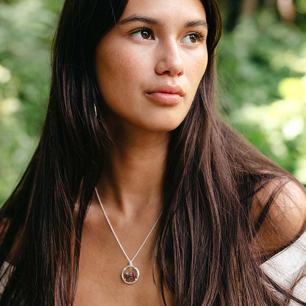 Woman outdoors wearing a delicate silver pendant necklace with a small shaker design, styled naturally with long dark hair and subtle makeup, Small Shaker Necklace | Catherine Weitzman Jewelry