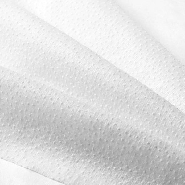 Close-up of textured white fabric or disposable cloth used with the Prep-N-Glow® | NuFACE skincare device for facial treatment and wellness care.
