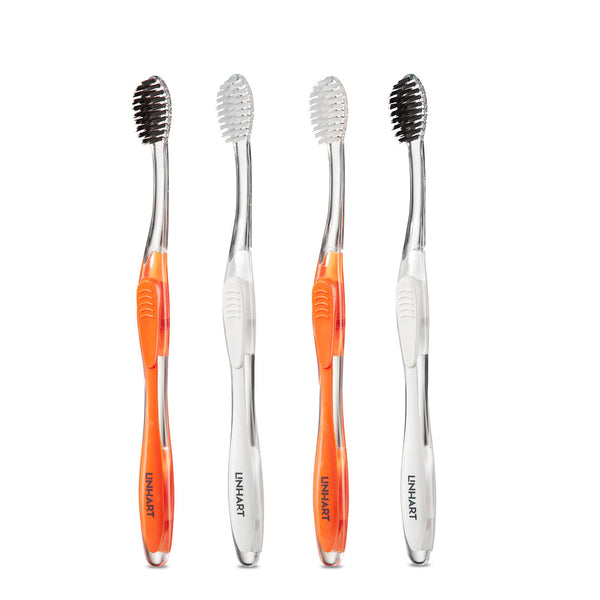Four Nano-Silver Toothbrush | LINHART with ergonomic handles, featuring alternating colors in orange and white, designed for effective oral wellness care.