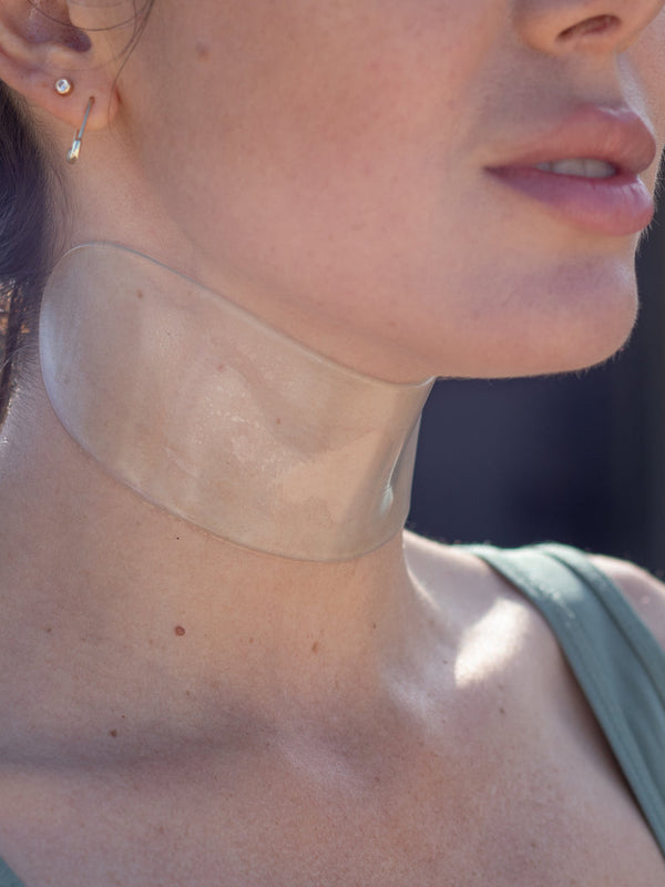 Close-up of a woman wearing a transparent SiliconeFusion™ Neck Patch | Dermaclara on her neck, highlighting smooth skin and skincare wellness.