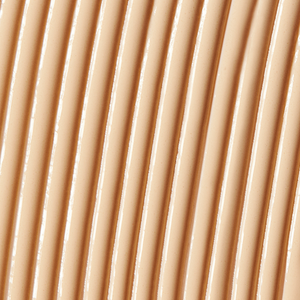 Close-up texture of a smooth, creamy beige skincare serum applied in parallel lines, representing Solarglow™ Mineral Serum Sunscreen | NUDA for a radiant, protective finish.