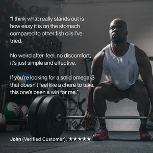 Athletic man in workout gear preparing to lift a barbell in a gym, alongside a customer testimonial praising the ease of taking Omega-3 supplements with no discomfort.