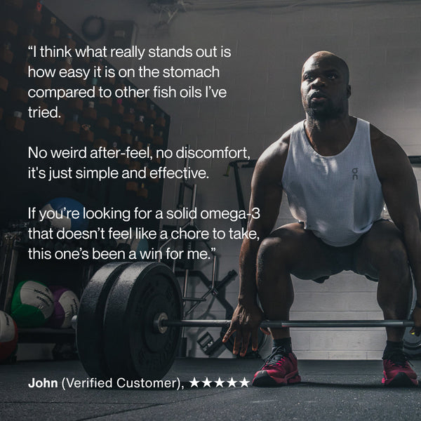 Athletic man in workout gear preparing to lift a barbell in a gym, alongside a customer testimonial praising the ease of taking Omega-3 supplements with no discomfort.