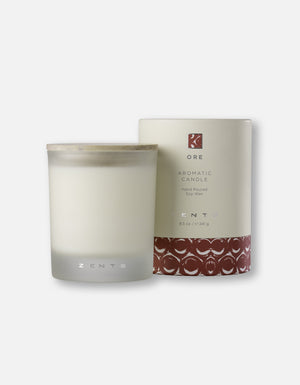 A frosted glass Aromatic Candle | Zents with a wooden lid next to a matching decorative cream and brown packaging featuring the brand and product details for wellness and ambiance.