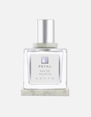 Clear glass bottle of Eau de Toilette | Zents with a silver cap and minimalist label featuring the name Petal, presented against a white background.