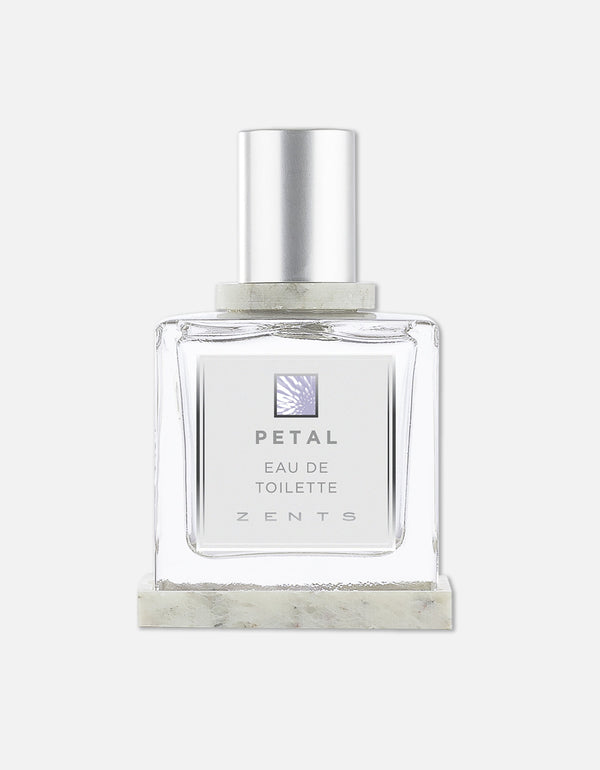Clear glass bottle of Eau de Toilette | Zents with a silver cap and minimalist label featuring the name Petal, presented against a white background.