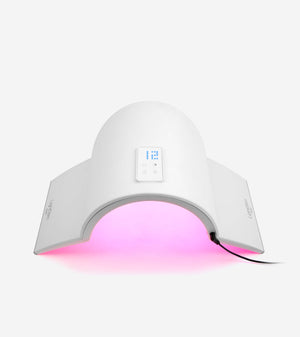 White wellness device Elipsa | LightStim with digital controls and arms emitting pink light for skincare and recovery treatments connected by a power cord