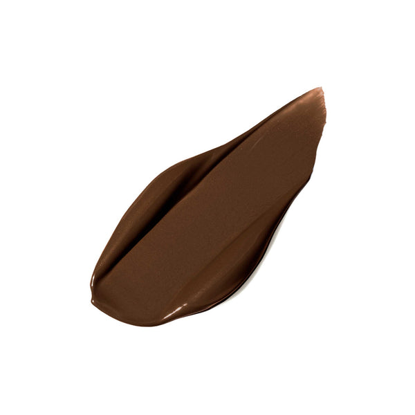 Creamy brown liquid concealer swatch on white background showcasing the smooth texture of PureMatch Liquid Concealer | Jane Iredale for skincare and beauty use.