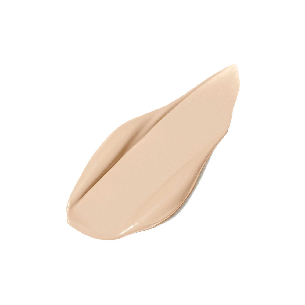Open tube of PureMatch Liquid Concealer | Jane Iredale with visible beige liquid concealer and applicator wand on a white background, showcasing skincare makeup product.