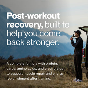 Man standing outdoors by a vehicle drinking a recovery supplement with text describing post-workout recovery as a formula with protein, carbs, amino acids, and electrolytes to support muscle repair and energy replenishment after training.