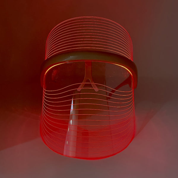 Red glowing LED Light Therapy Visor | Vie Healing with clear curved shield and light lines for skincare and wellness treatment.