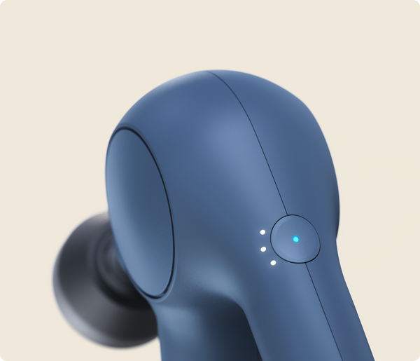 Close-up of the navy blue Theragun Relief | Therabody muscle recovery tool, highlighting its smooth ergonomic design and illuminated power button for wellness and body care.