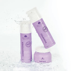 Purple bottles of Heat Guard Conditioner | SUTRA and matching shampoo and hair mask with water splashing around, emphasizing hydration and hair care.