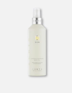 Bottle of Body Oil | Zents in a light translucent container with a silver pump, labeled with "Sun" and featuring organic coconut and passionflower ingredients for skincare and body care.