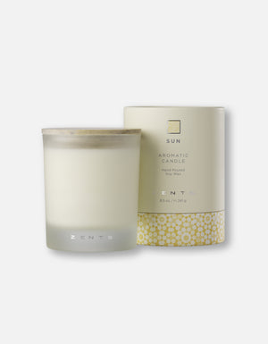 Aromatic Candle | Zents in a frosted glass container with a wooden lid, displayed next to its beige packaging featuring a yellow floral pattern, promoting a soothing wellness ambiance.