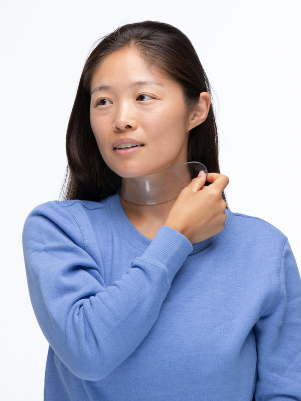 Woman wearing a transparent silicone patch on her neck demonstrating the SiliconeFusion™ Neck Patch | Dermaclara for skincare and neck wrinkle improvement.