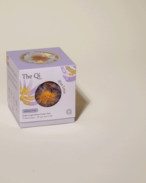 Packaging of Blue Lotus Whole Flower Tea | The Qi with a clear window showing dried blue lotus flower tea inside, displayed on a neutral background.