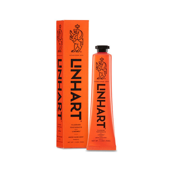 Bright orange tube and box packaging of Linämel Toothpaste | LINHART featuring minimalist black text and a stylized lion logo, designed for dental care and wellness.