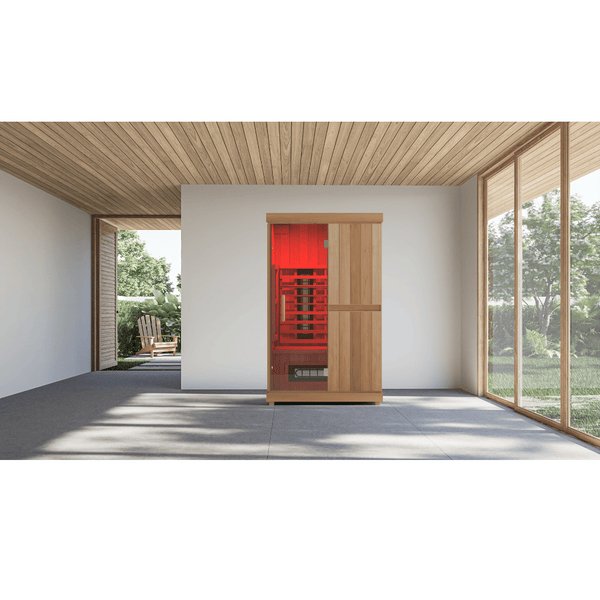 FD2 Sauna - 2 Person | Western Sol wooden sauna cabin with glowing red interior lighting, set in a modern room with large windows and outdoor garden view for wellness and relaxation.