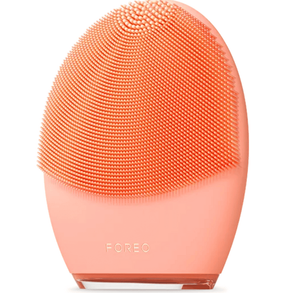 LUNA™ 4 | FOREO facial cleansing device in coral pink with soft silicone bristles designed for gentle and effective skincare and body care routines.