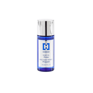 Clear blue bottle with a silver cap containing Treatment Shave Oil - Prime 30mL | Hommage, a skincare product designed for a smooth shaving experience.