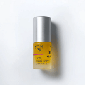 Glass bottle of Booster Nutri+ | Yon-Ka Paris, a nourishing facial oil with a silver cap, shown on a white background for skincare and wellness.