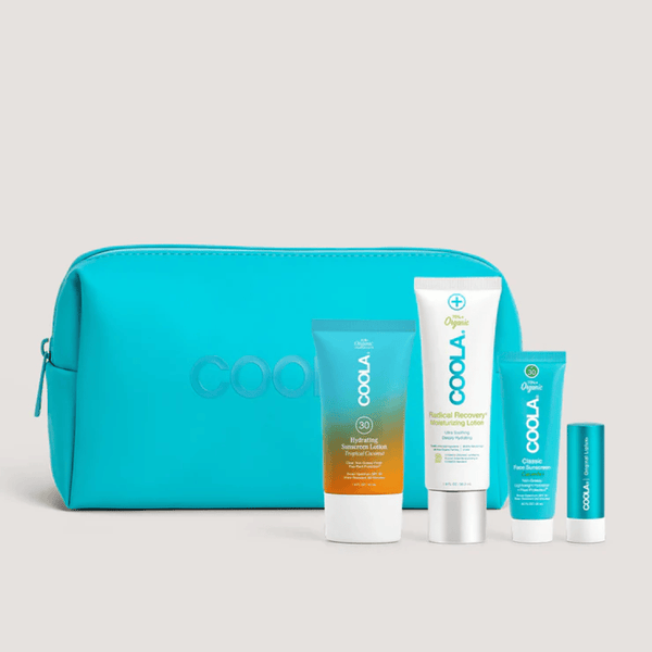 Suncare Travel Essentials Set | COOLA featuring a turquoise travel pouch with sunscreen, moisturizing lotion, face butter, and lip care products for skincare and sun protection.