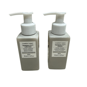 Two beige pump bottles of Tranquillity Hair Kit | [ comfort zone ] featuring aromatic shampoo and conditioner with cedarwood and sweet orange oils for relaxation and wellness.