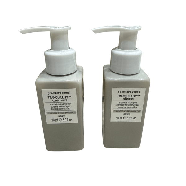 Two beige pump bottles of Tranquillity Hair Kit | [ comfort zone ] featuring aromatic shampoo and conditioner with cedarwood and sweet orange oils for relaxation and wellness.