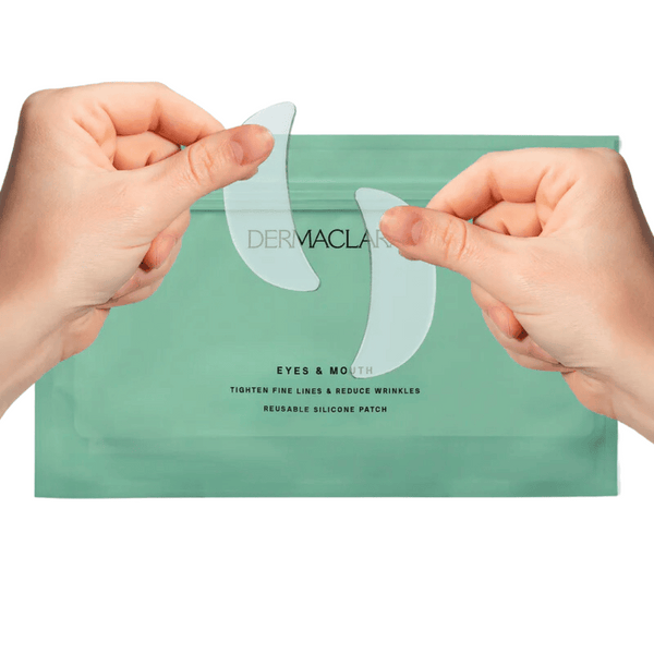 Hands holding clear silicone patches above a green pouch labeled SiliconeFusion™ Eyes & Mouth Patches | Dermaclara, designed to tighten fine lines and reduce wrinkles in skincare.
