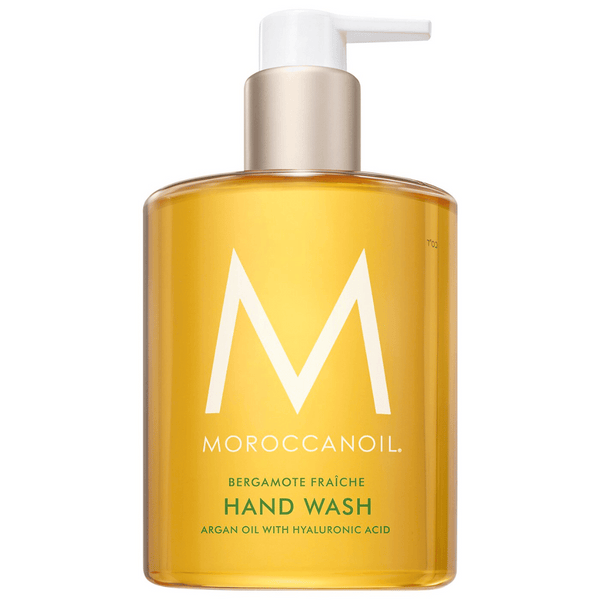 Clear amber bottle with a white pump containing Hand Wash | Moroccanoil featuring argan oil and hyaluronic acid, designed for skincare and body care wellness.