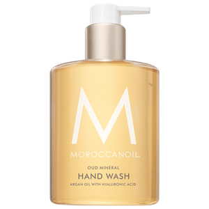 Bottle of Hand Wash | Moroccanoil with pump dispenser containing golden liquid infused with argan oil and hyaluronic acid for skincare and body care.