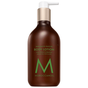 Brown pump bottle of Body Lotion | Moroccanoil featuring lightweight hydration with argan oil and aloe, labeled with green text and gold pump top for skincare and body care.