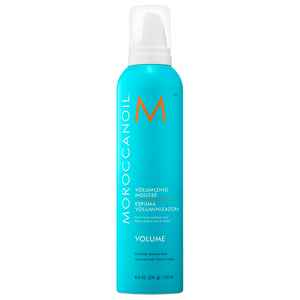Bright turquoise bottle of Volumizing Mousse | Moroccanoil designed for fine to medium hair, featuring a white pump dispenser and orange brand logo.