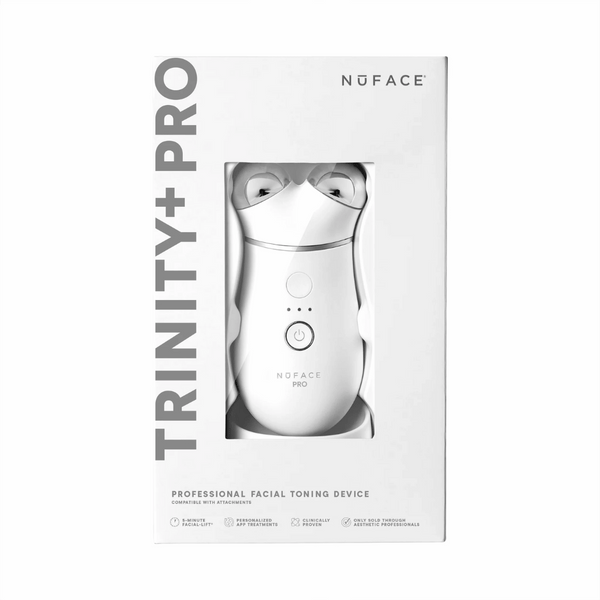 Packaging of the Trinity+ Pro | NuFACE professional facial toning device in white, featuring a sleek handheld design visible through a transparent window.