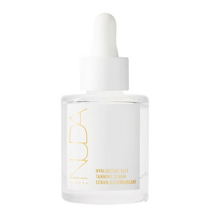 Clear glass bottle of Hyaluronic Self Tanning Serum | NUDA with white dropper cap, featuring minimalist gold and white label design for skincare and body care.
