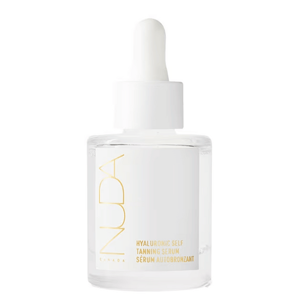 Clear glass bottle of Hyaluronic Self Tanning Serum | NUDA with white dropper cap, featuring minimalist gold and white label design for skincare and body care.