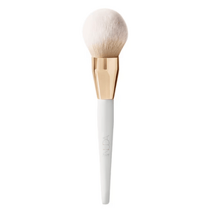 Bronzing Powder Brush | NUDA with soft, fluffy bristles and a sleek white handle featuring a gold-toned ferrule, designed for effortless makeup application and a natural finish.