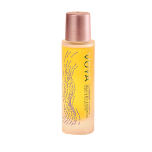 A frosted bottle with a rose gold cap containing Moonlight Moments Bath & Shower Oil | VOYA, designed for skincare and body care with a subtle wave pattern on the label.
