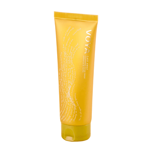 Yellow tube of Cast Away Cleansing Facial Wash | VOYA standing upright with white text and delicate wave design, showcasing natural skincare in a sleek package.
