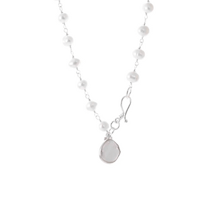 Close-up of a delicate pearl bracelet with a silver clasp and a small pendant, featuring elegant white pearls in a classic design titled It's A Wrap Triple Pearl Bracelet | Liv & B.