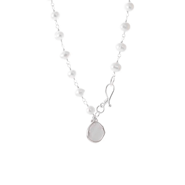 Close-up of a delicate pearl bracelet with a silver clasp and a small pendant, featuring elegant white pearls in a classic design titled It's A Wrap Triple Pearl Bracelet | Liv & B.