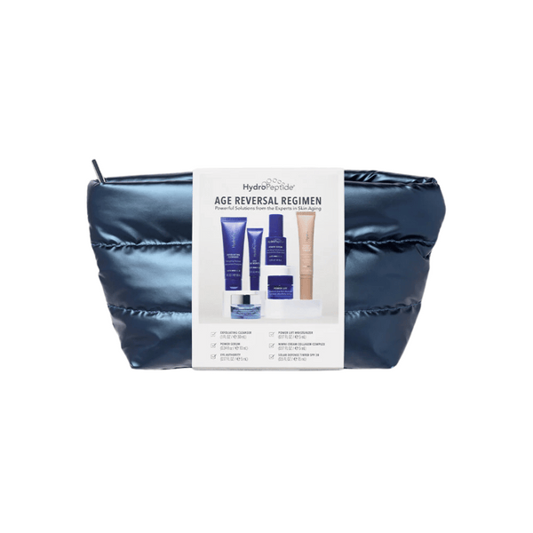 Blue cosmetic bag containing a skincare set with tubes and jars labeled Age Reversal Regimen | HydroPeptide for anti-aging and skin care wellness.