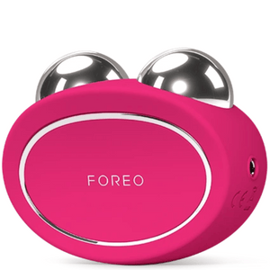 BEAR™ 2 | FOREO in bright pink with two polished metal spheres designed for facial skincare and muscle toning as a wellness device.