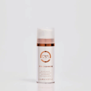 Elegant skincare bottle of Cashmere | OYA with a rose gold accent and clear cap, designed for split ends treatment and promoting wellness care.